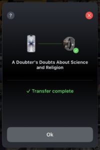 Watch screen showing green checkmark / transfer complete